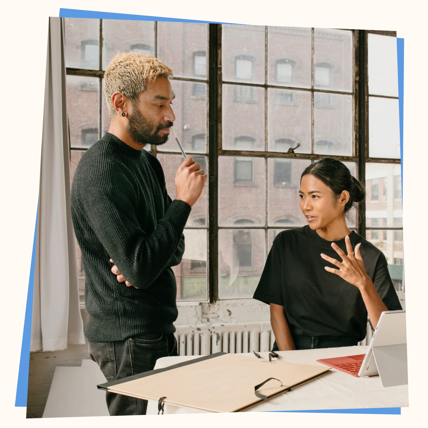 Two professionals discussing a project in a modern workspace, representing seamless contractor onboarding and management with digital tools.