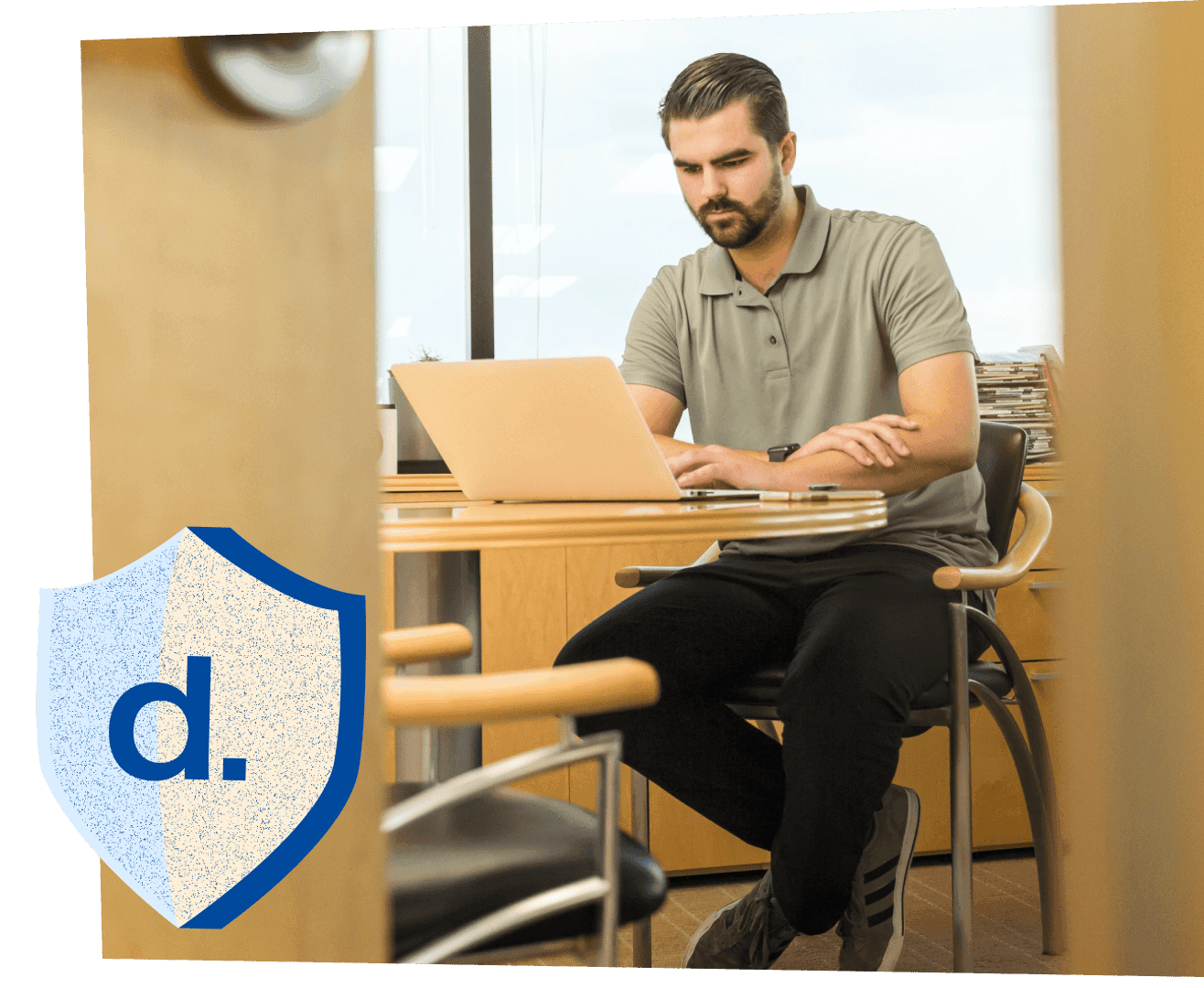 A professional working on a laptop in a modern office, symbolizing the efficiency and compliance of a Contractor of Record solution for managing global talent.